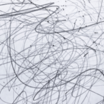 Abstract black and gray scribbles on a light gray background, links to more information