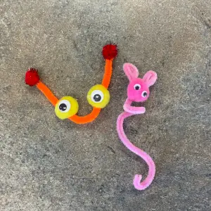 Two puppets made from pipe cleaners, with googly eyes & pom-poms, links to more information