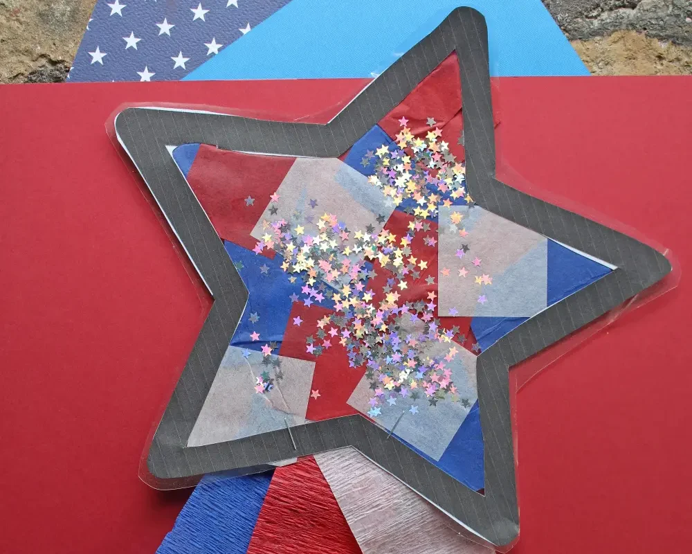 Photo shows an art project of a star decorated with tissue paper