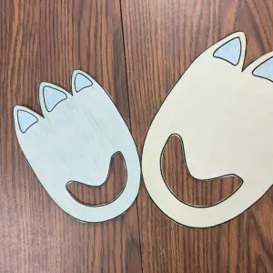 Two blue & green dinosaur footprint paper cutouts on a wooden surface, links to more information