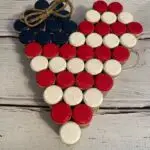 Photo of heart shaped flag made of red, white, and blue painted corks.