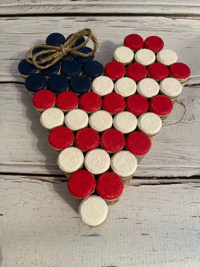 Photo of heart shaped flag made of red, white, and blue painted corks.