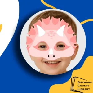 Blue and yellow background with Shawano County Library logo in lower corner. Photo of boy with pink dinosaur mask on his face.
