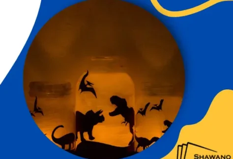 Blue and yellow background with photo of dinosaur silhouettes on a candle.