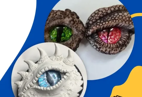 Blue background. Clay white and brown dragon eyes with green, red and blue eyes. Shawano County Library logo.