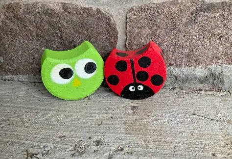 Image of a ladybug and an owl painted on concrete paving bricks
