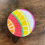 Colorful circular coaster with fruit slice designs, links to more information