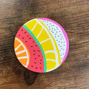 Colorful circular coaster with fruit slice designs, links to more information