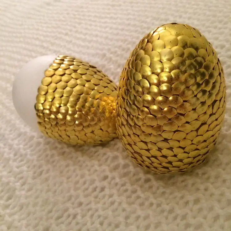 Styrofoam eggs covered with gold thumbtacks