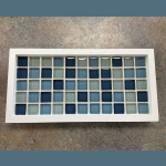 A grid of glass tiles in shades of blue and green, in a white tray, links to more information