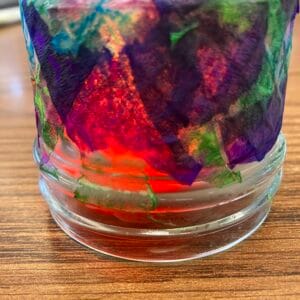 Image of colorful tissue paper glued to a glass jar