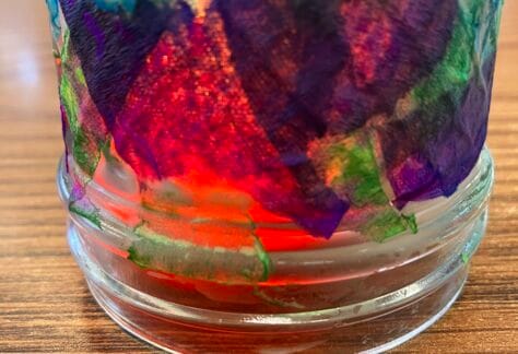 Image of colorful tissue paper glued to a glass jar