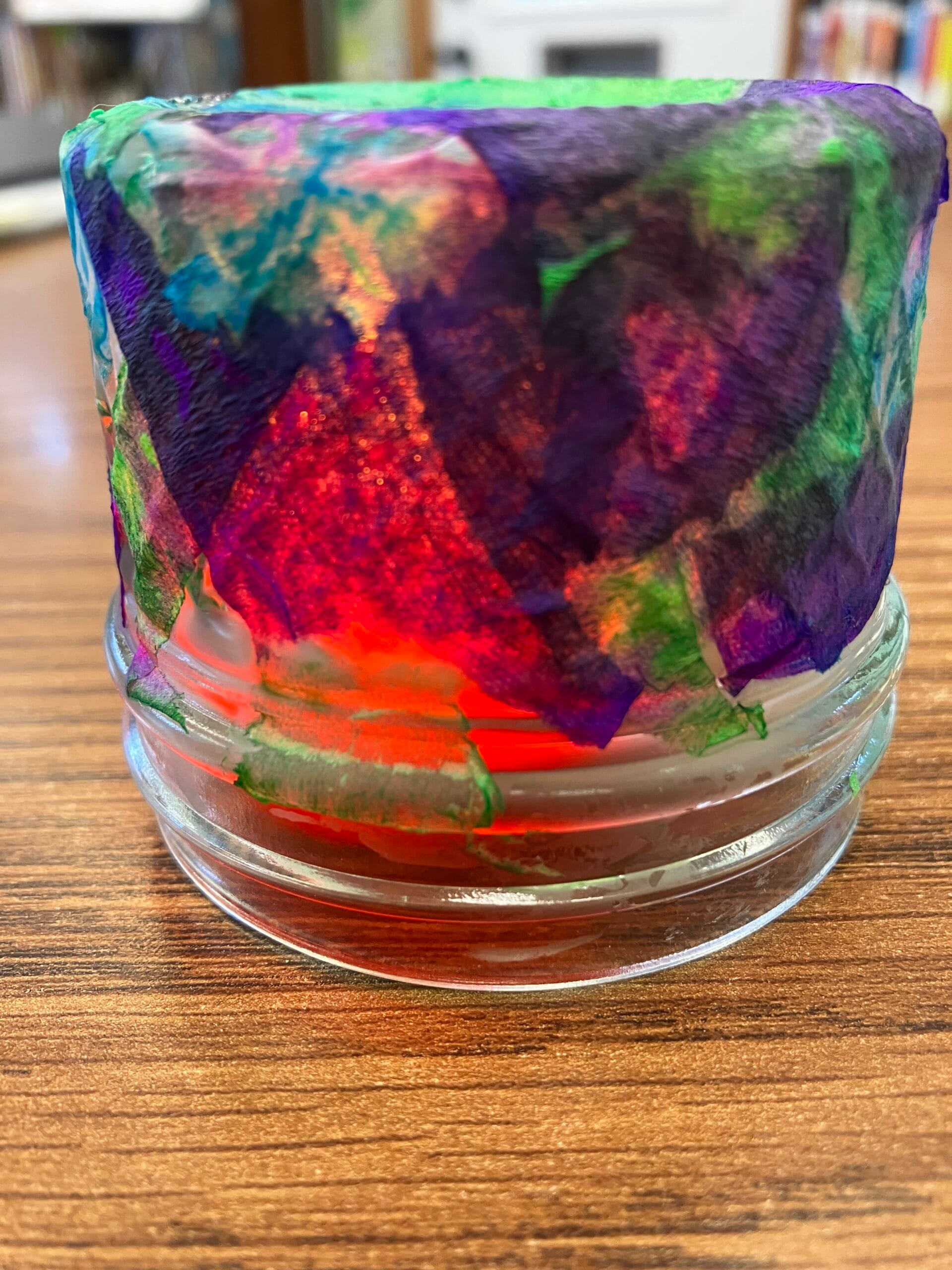 Image of colorful tissue paper glued to a glass jar