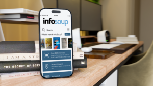 A smartphone with the InfoSoup App on it, sitting on a desk. Links to website.