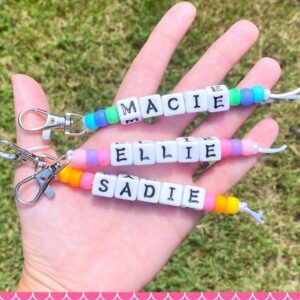 Image of 3 beaded keychains with name beads.